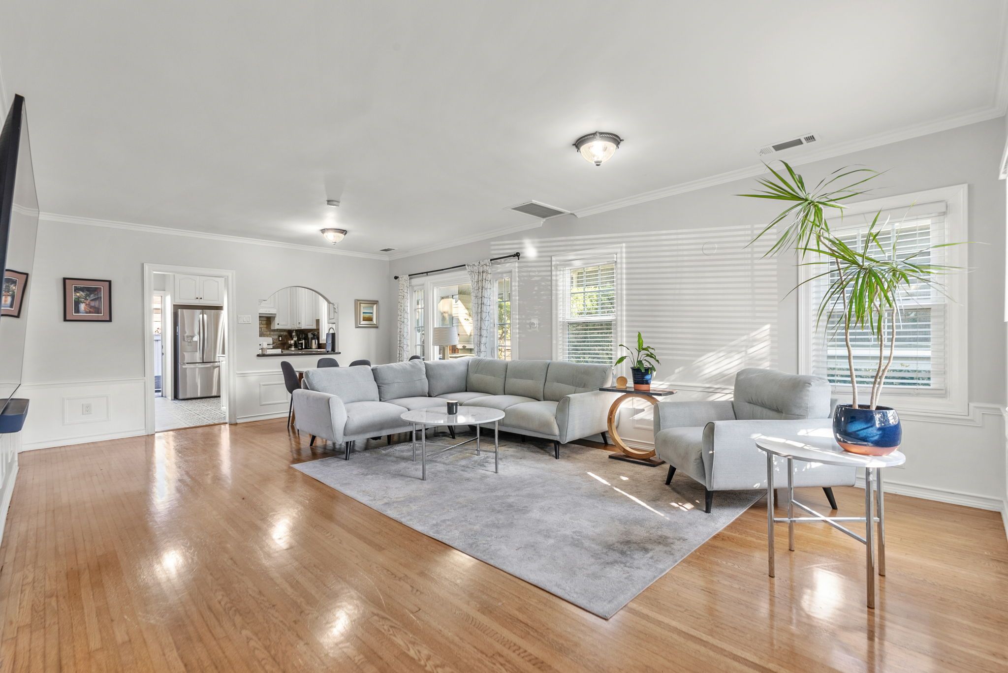 Living room with hardwood floors and a wide sofa