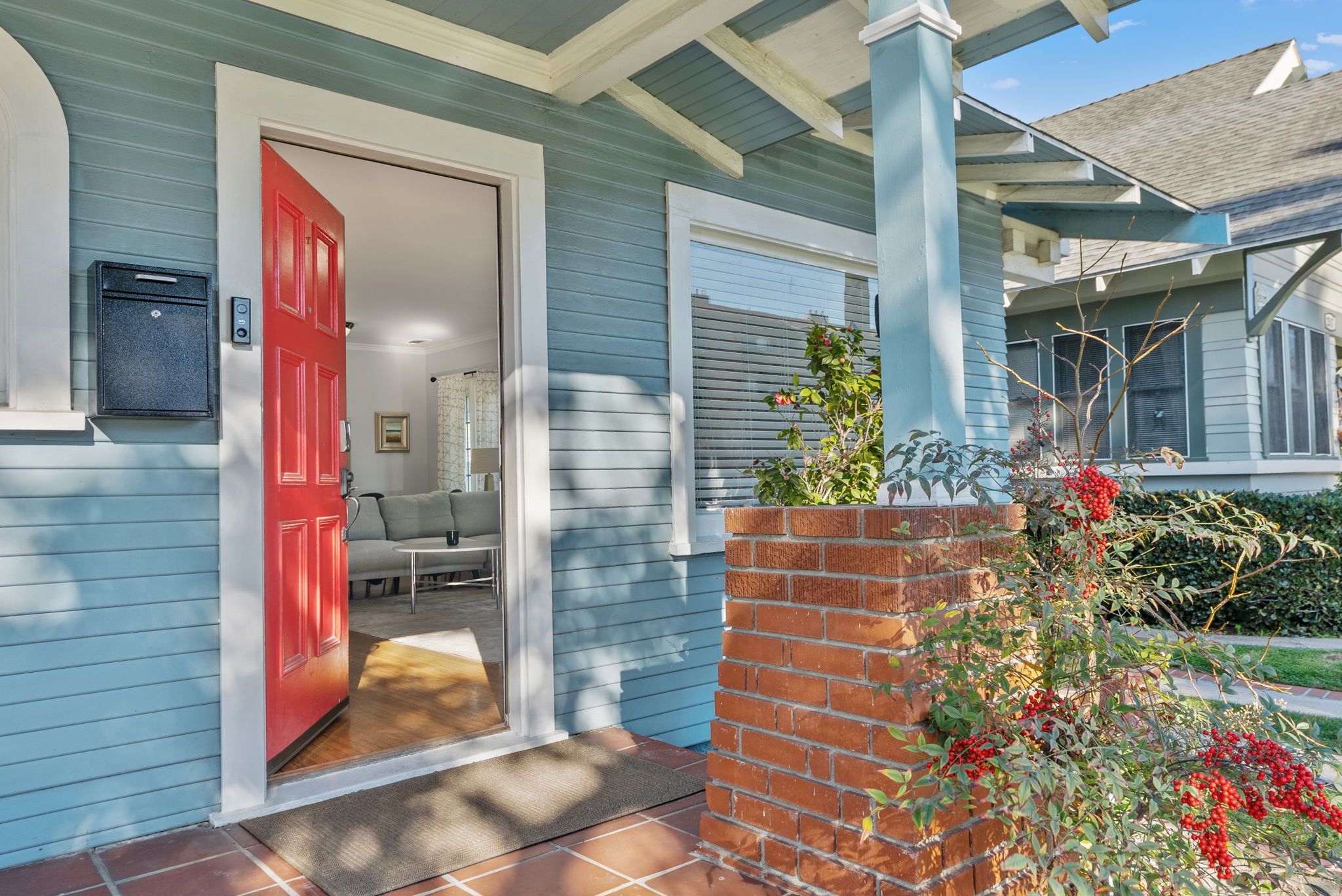 The red front door under the porch